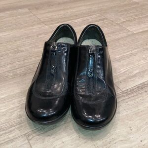 Women’s black patent center zip shoes. Coke Haan.